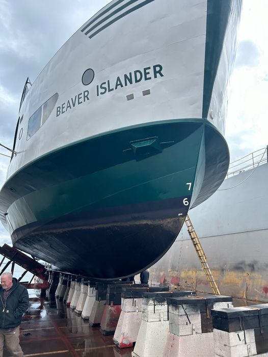 May be an image of 1 person, boat and text that says 'ISLANDER ISLANDER BEAVER BEAVER 7 6'
