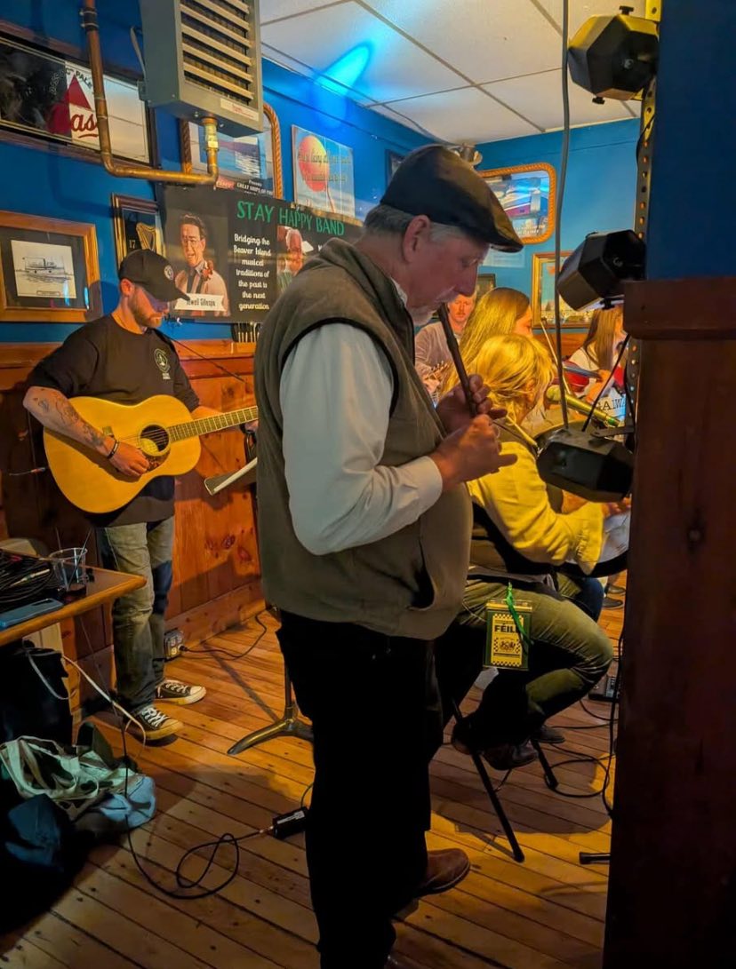 May be an image of 4 people, dartboard, clarinet, violin, saxophone, guitar and accordion